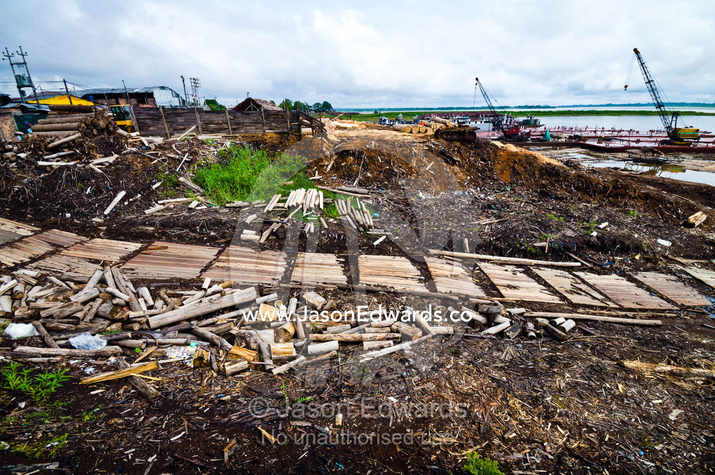 Logs, sawdust and pollution along a ramp used to transport logs from Amazon River barges to mills. Puerto Masusa, Iquitos, Amazon River, Rio Amazonas, Amazon Basin, Loreto Region, Maynas Province, Peru.