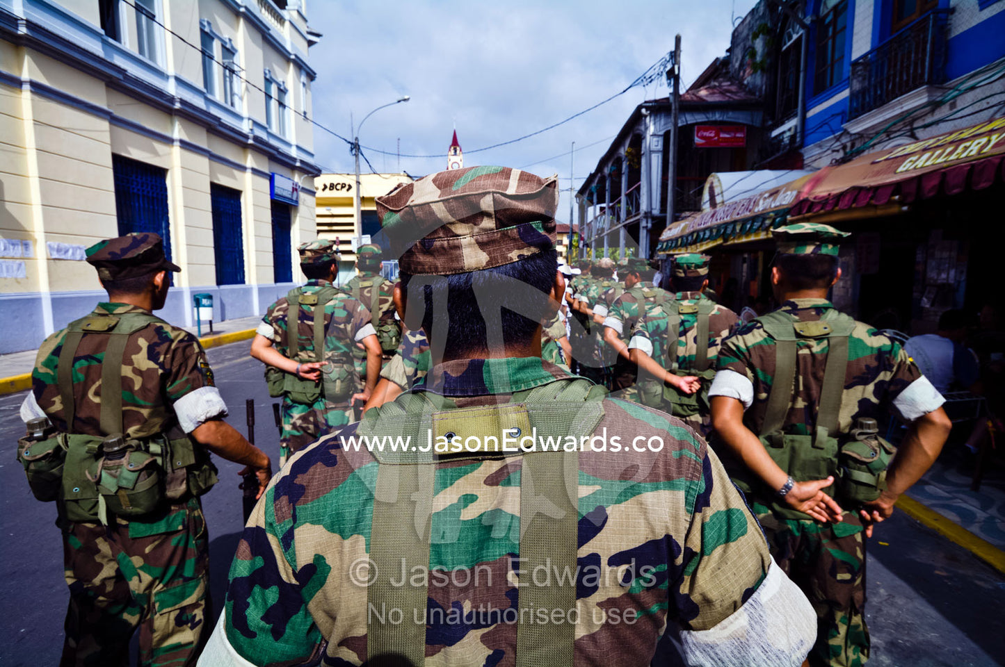 Army soldiers standing in formation with their rifles at a military parade honoring fallen comrades. Plaza de Armas, Iquitos, Amazon Basin, Loreto Region, Maynas Province, Peru.