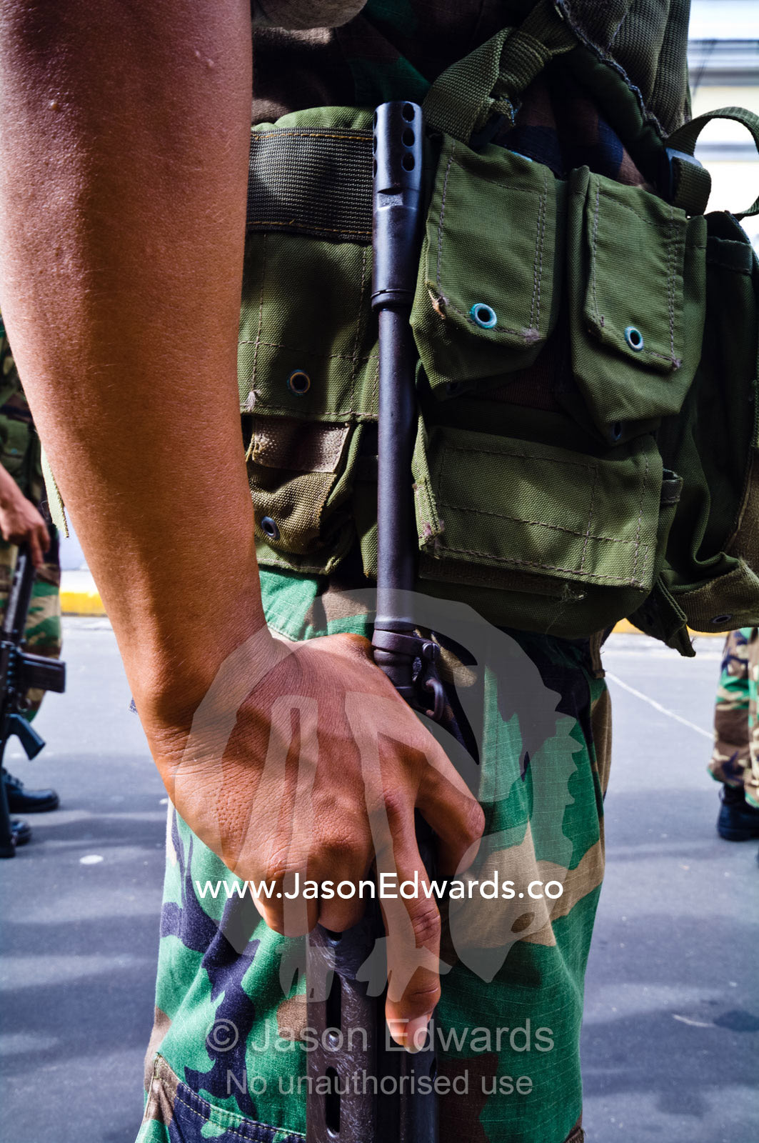 Army soldiers standing in formation with their rifles at a military parade honoring fallen comrades. Plaza de Armas, Iquitos, Amazon Basin, Loreto Region, Maynas Province, Peru.