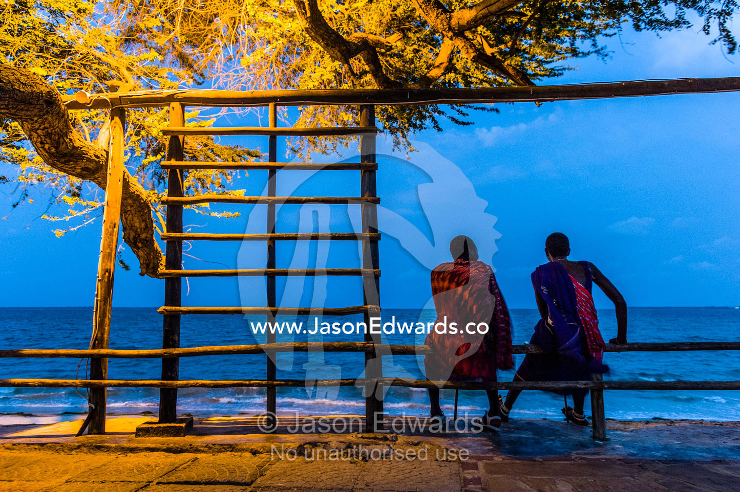 Young Masai warriors lured to the city wait to entertain guests at a seaside hotel. Dar es Salaam, Kawe, Tanzania, Africa.