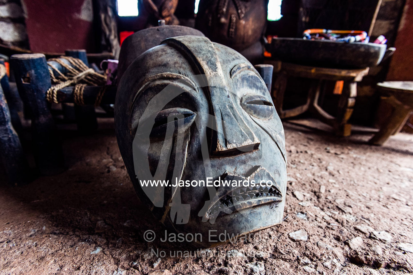 A fearsome African mask carved from wood for sale in a village. Mto Wa Mbu, Lake Manyara National Park, Monduli District, Arusha Region, Tanzania.