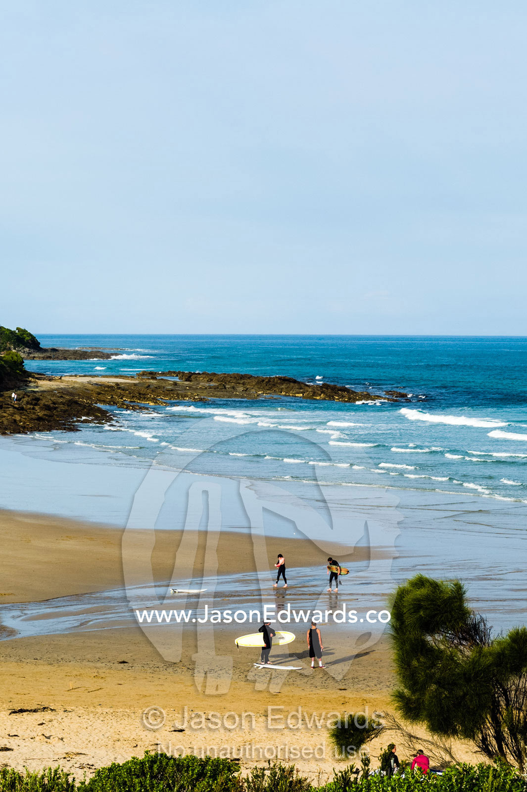Surfers chatting on the beach after catching a few winter waves. Wye River, Great Ocean Road, Victoria, Australia.