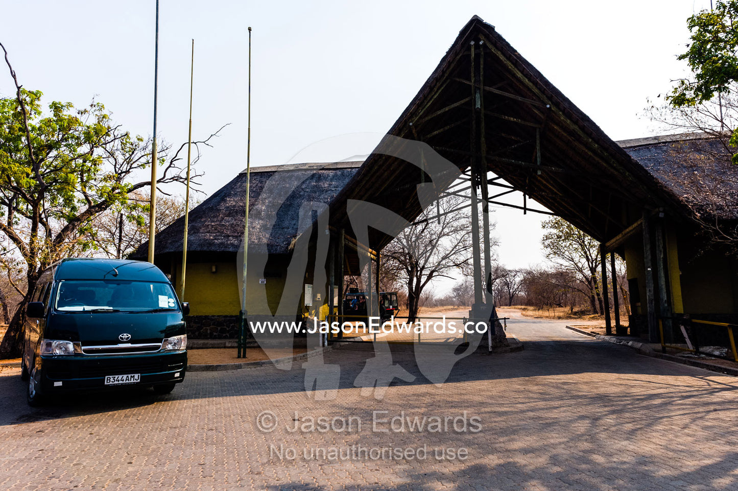 The thatched roof of a guard house and gate entry to a national park. Chobe River, Chobe National Park, Botswana.