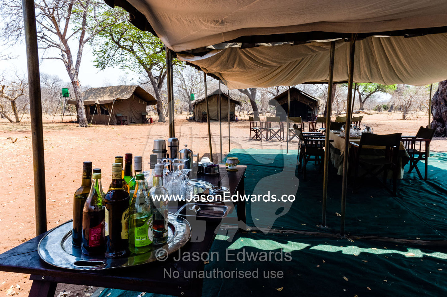 A tented safari camp dining room and alcohol bar in a national park. Chobe River, Chobe National Park, Botswana.
