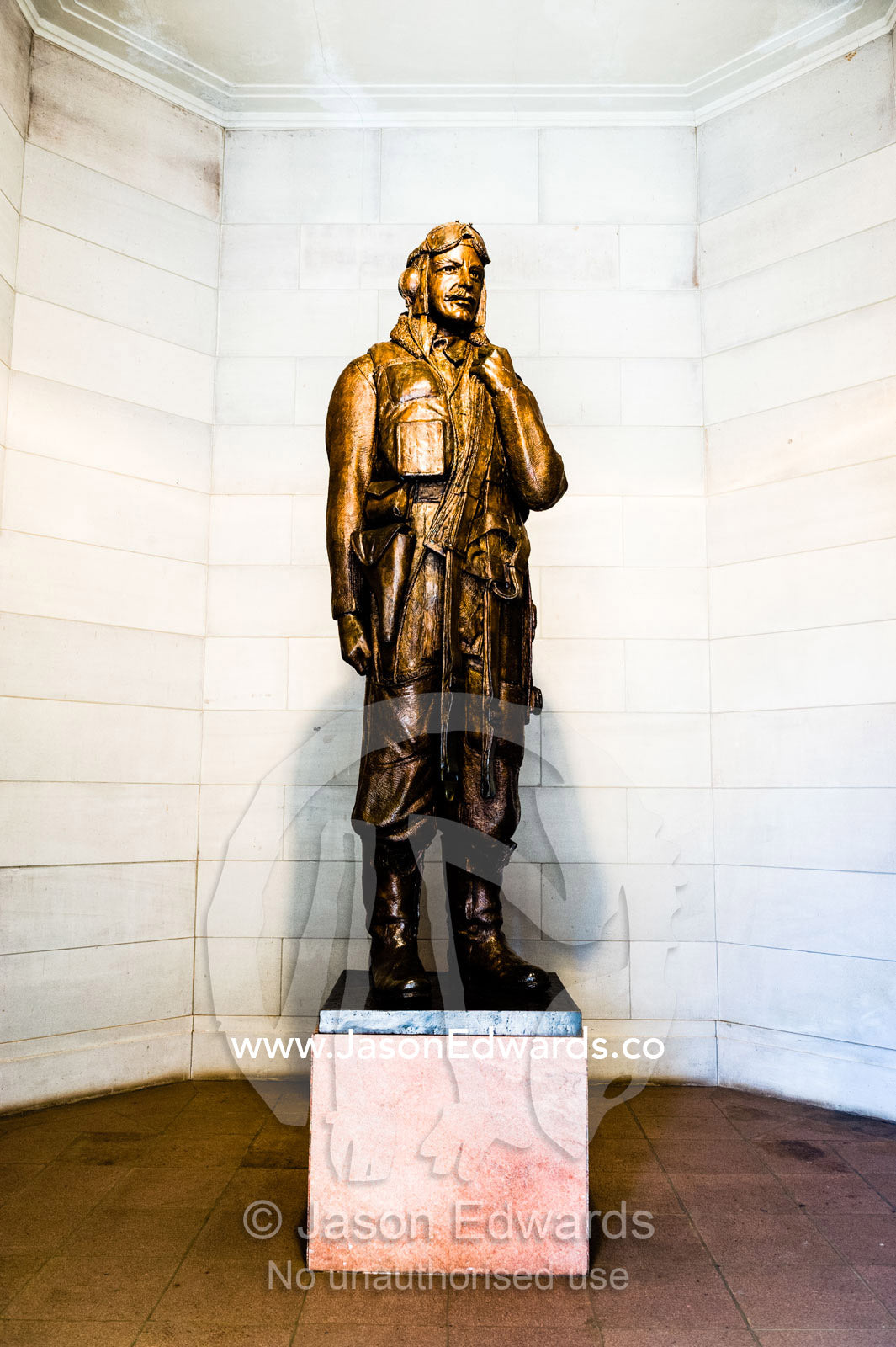A bronze statue of a Second World War airman wearing full flying kit and carrying a parachute over his shoulder. Australian War Memorial, Canberra, Australian Capital Territory, Australia.