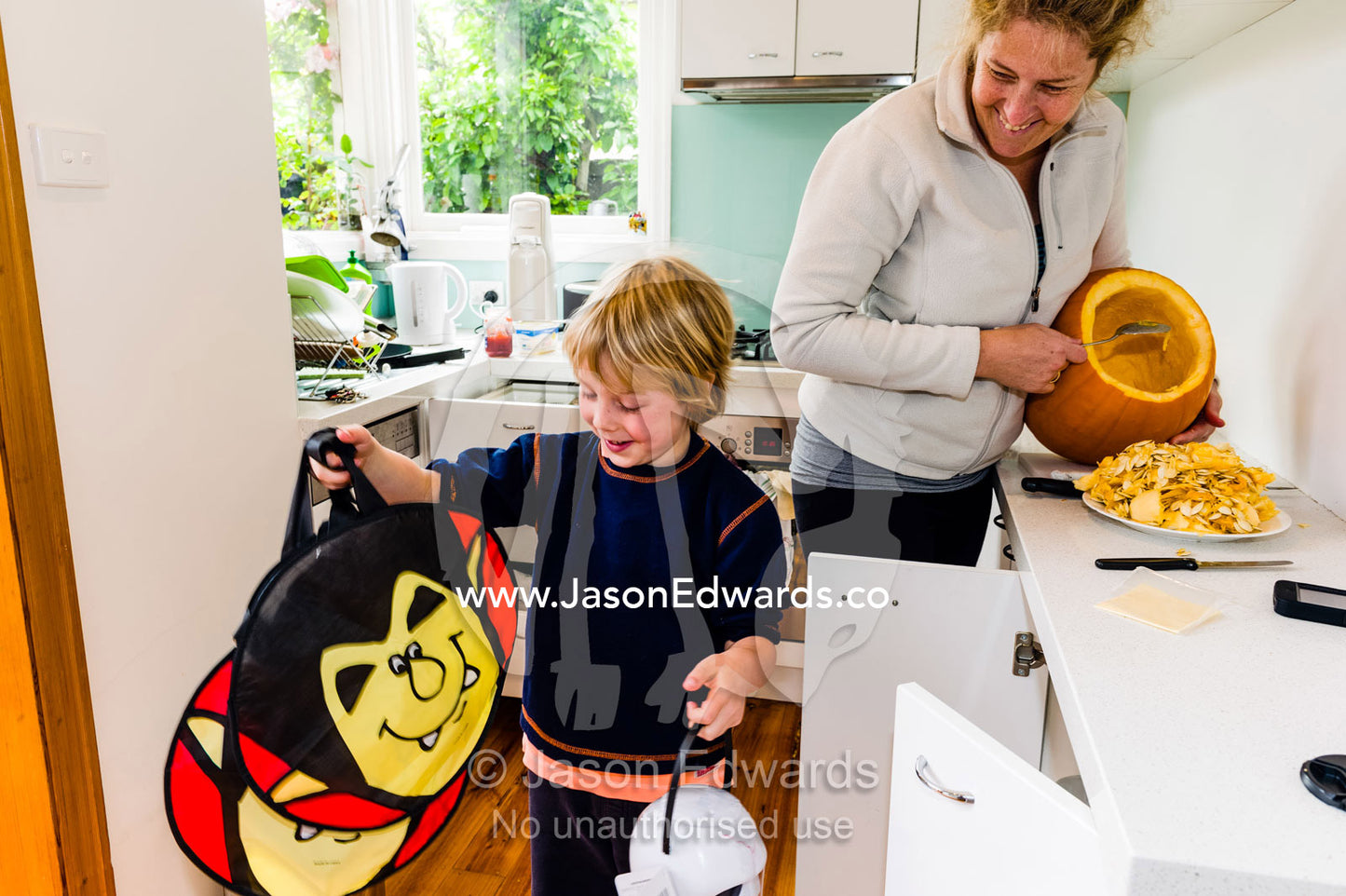 A boy prepares his halloween bags to collect trick-or-treat candy. Carlton North, Melbourne, Victoria, Australia.