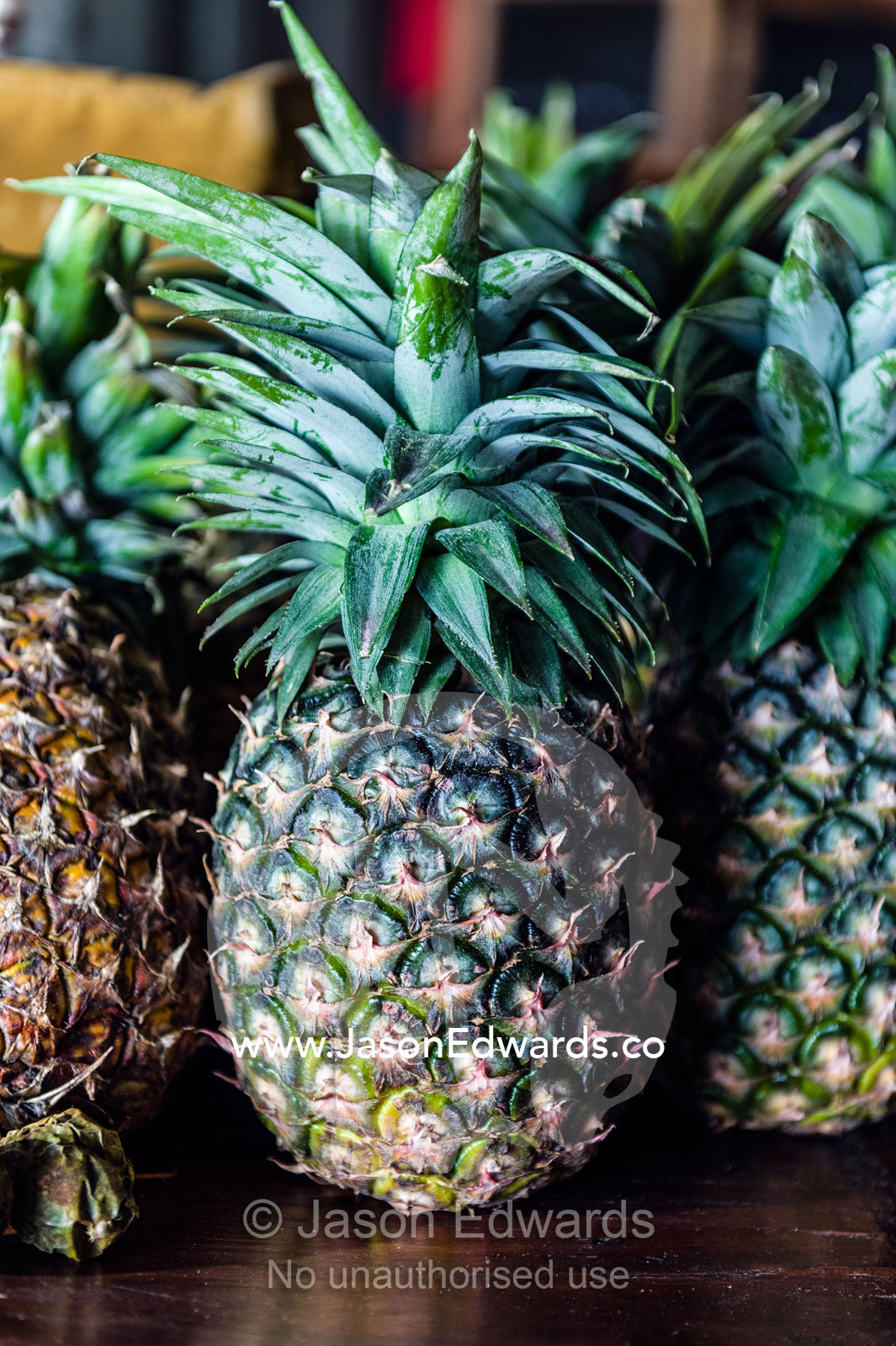 Fresh spiky pineapples resting on a shelf in a breakfast dining room. Karatu, Rhotia Valley Lodge, Rhotia Valley, Karatu District, Arusha Region, Tanzania.