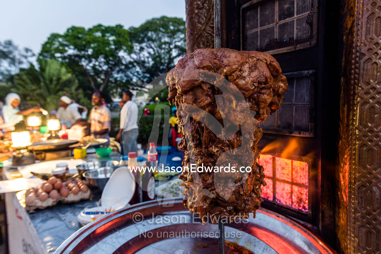 Lamb being flame-grilled for sale in a stall at a night food market. Forodhani Gardens, Stone Town, Mji Mkongwe, Zanzibar, Unguja Island, Zanzibar, Tanzania.