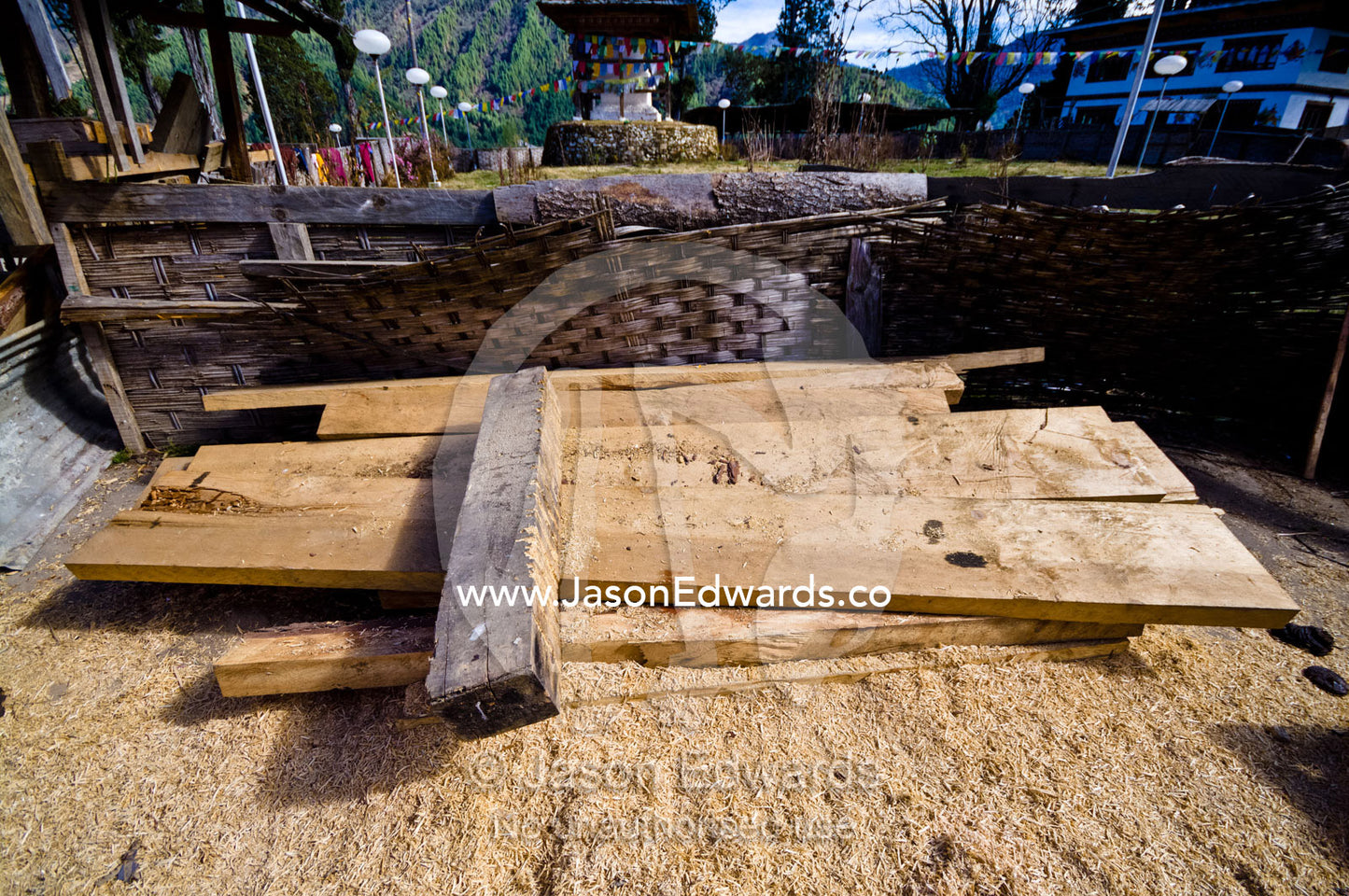 Freshly sawn timber beams surrounded by sawdust to be used to renovate a Buddhist monastery. Gangteng Monastery, Ganteng, Wangdue Phodrang District, Phobjika Valley, Phobjikha Valley, Gangteng Valley, Black Mountains, Bhutan.