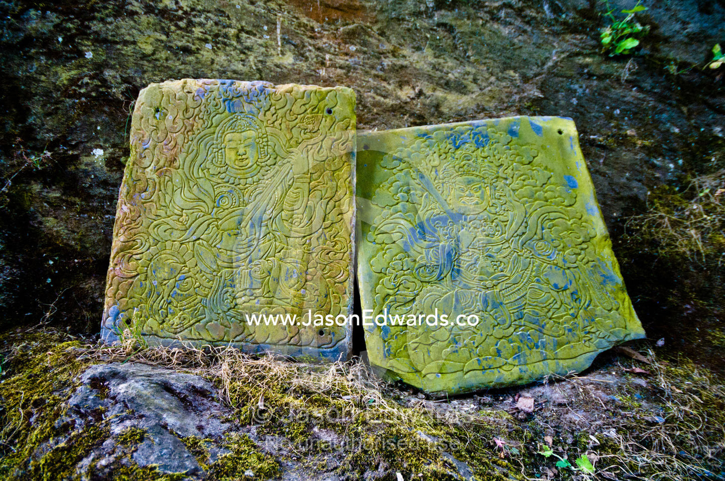Lichen encrusted stone tablets at a Buddhist monastery featuring engravings of two bodhisattvas Cheri Monastery, Chagri Dorjeden Monastery, Thimphu, Thimphu District, Bhutan.