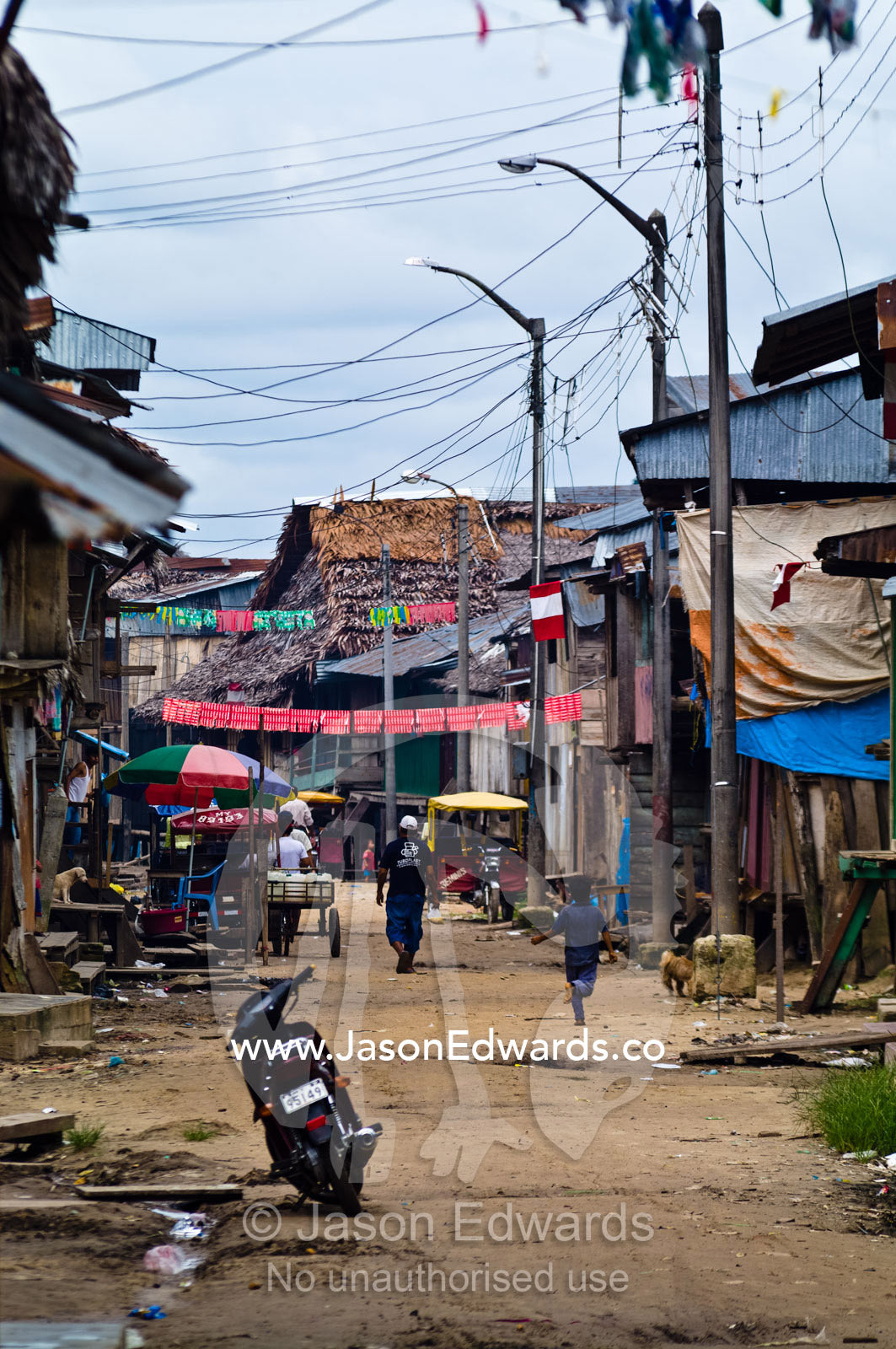 A scooter stands alone in a back alley of Iquitos Peru waiting for its owners return Puerto Masusa, Iquitos, Amazon Basin, Loreto Region, Maynas Province, Peru.