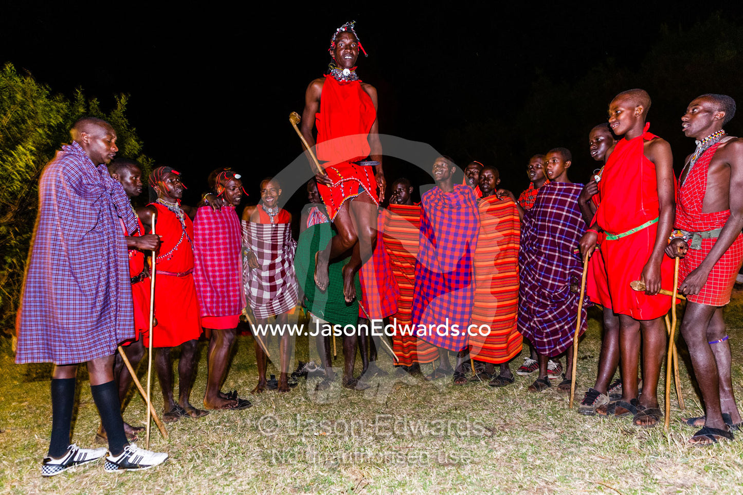 Maasai warriors jump during a ceremonial display known as a adumu or aigus. Near Maasai Mara National Reserve, Narok County, Kenya.