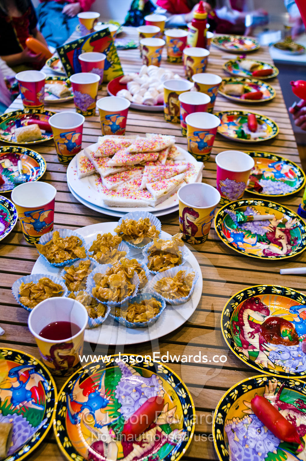 Party food and drinks fill a table at a children's birthday party. Carlton North, Melbourne, Victoria, Australia.