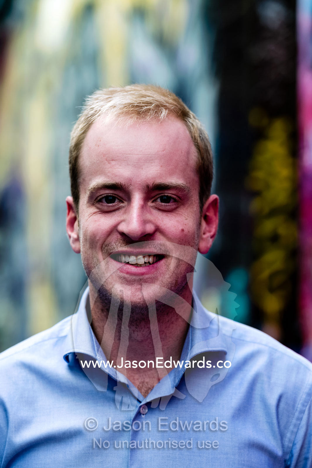 A young, confident and progressive businessman smiling in a collared shirt. St Kilda Road, Melbourne, Victoria, Australia.