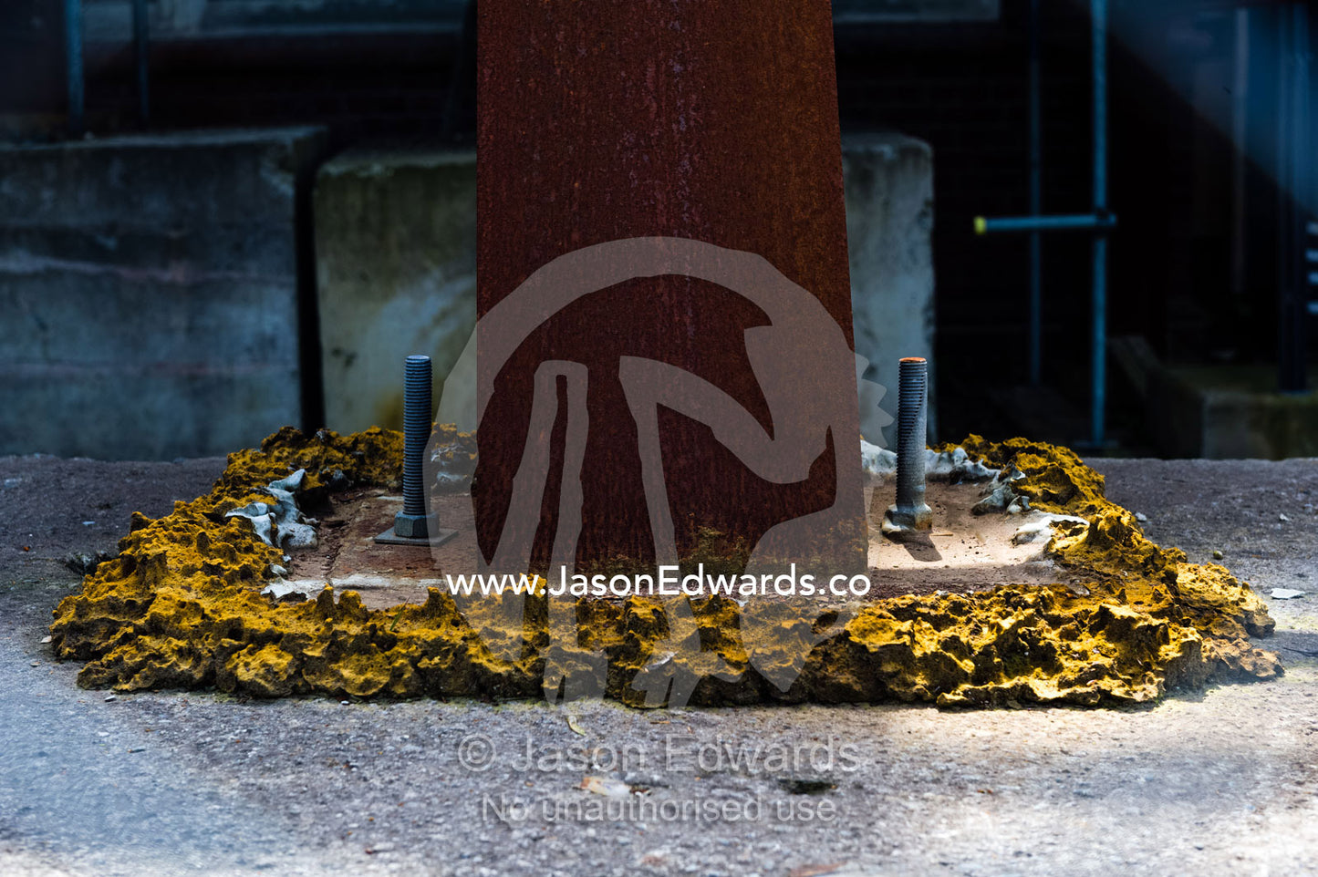 A steel girder is bolted and glued to a sidewalk to support a building damaged in an earthquake. Christchurch, South Island, New Zealand.