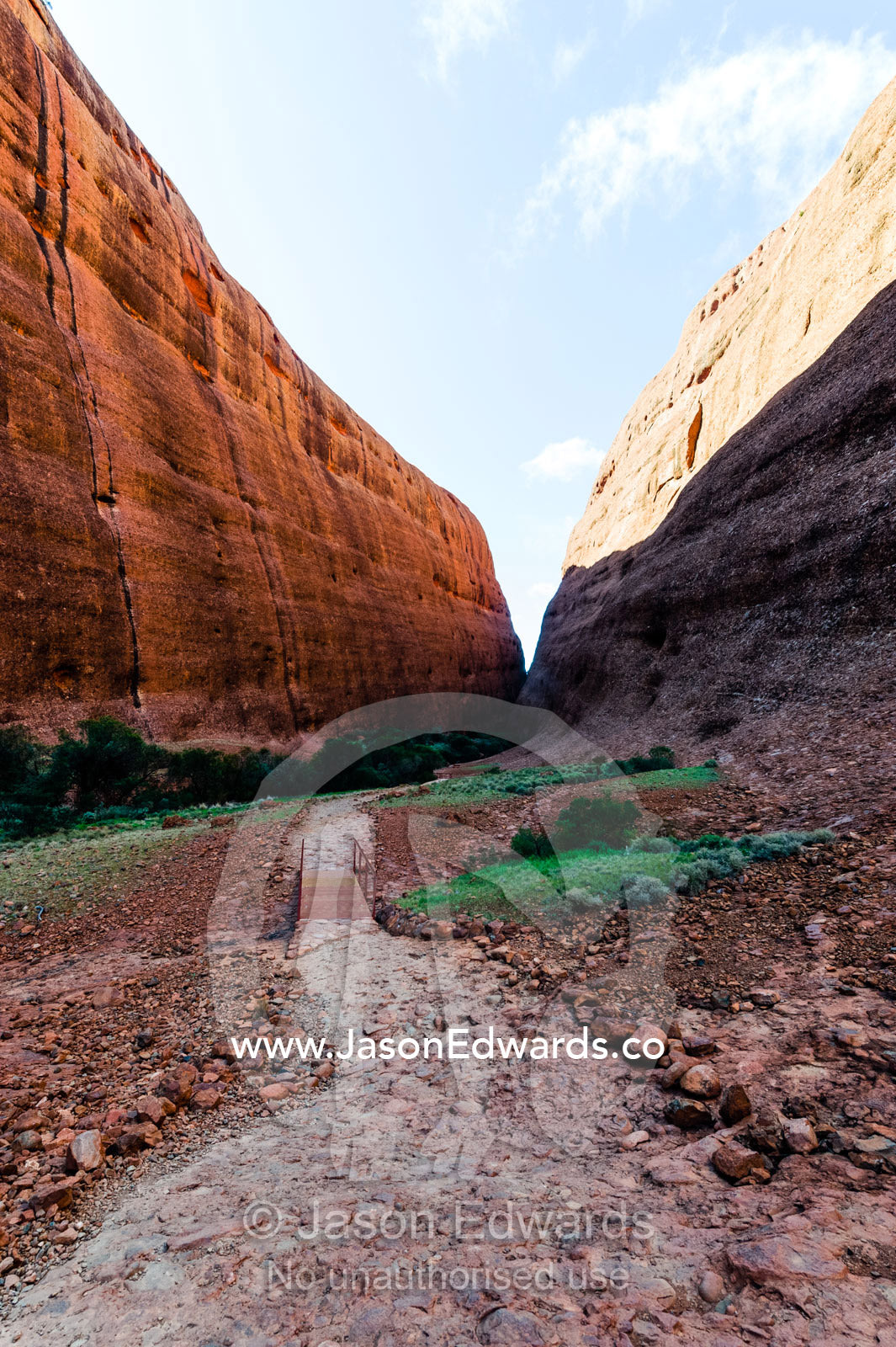 A hiking trail leads between the sandstone domes of Kata Tjuta in the Australian outback. Uluru Kata Tjuta National Park, Northern Territory, Australia.