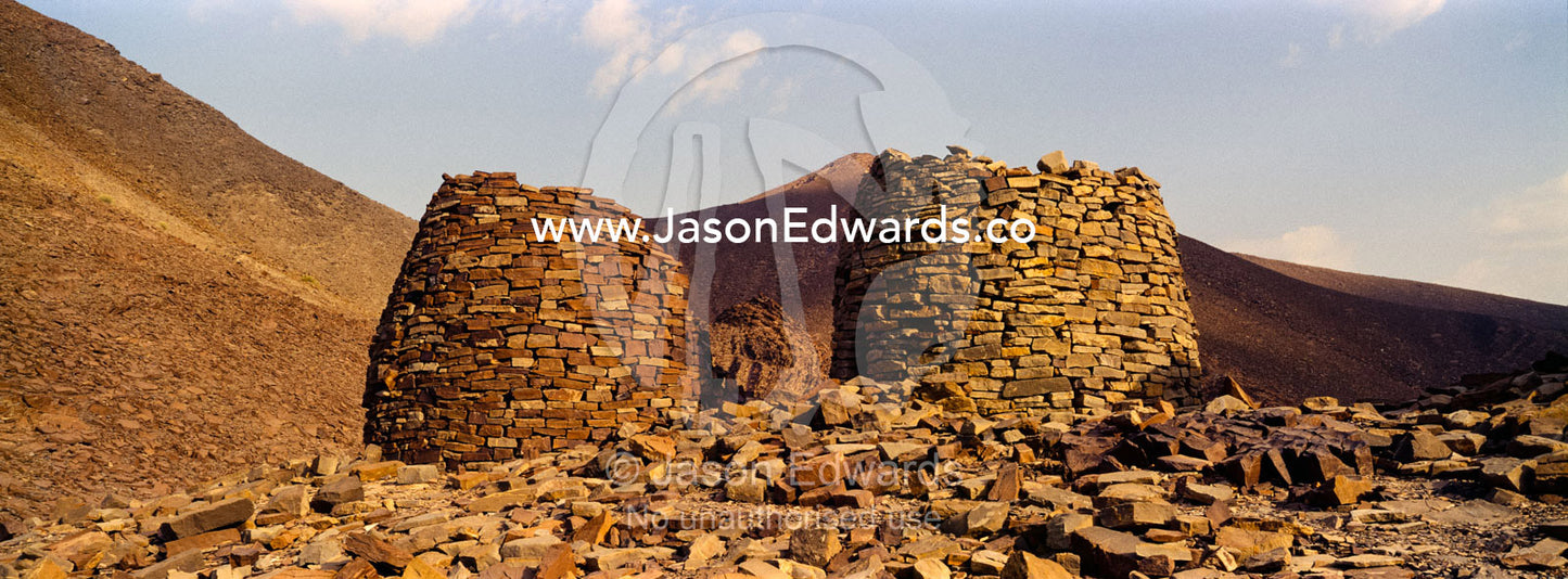 Ancient handmade stone burial mounds and tombs atop a desert ridge. Archaeological Sites of Bat, Al-Ayn, Al Dhahira Region, Sultanate of Oman.