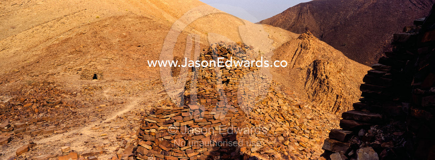Ancient handmade stone burial mounds and tombs atop a desert ridge. Archaeological Sites of Bat, Al-Ayn, Al Dhahira Region, Sultanate of Oman.