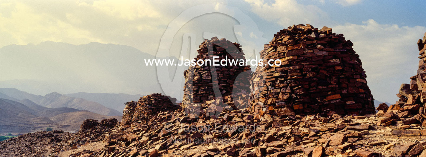 Ancient handmade stone burial mounds and tombs atop a desert ridge. Archaeological Sites of Bat, Al-Ayn, Al Dhahira Region, Sultanate of Oman.