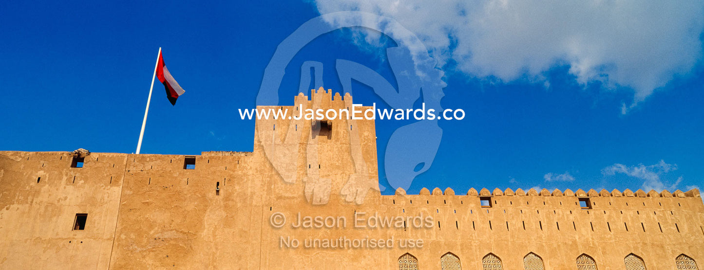 The ancient walls, parapets, battlements and watch tower of a fort. Jabrin Fort, Ad Dakhiliyah Governorate, Sultanate of Oman.