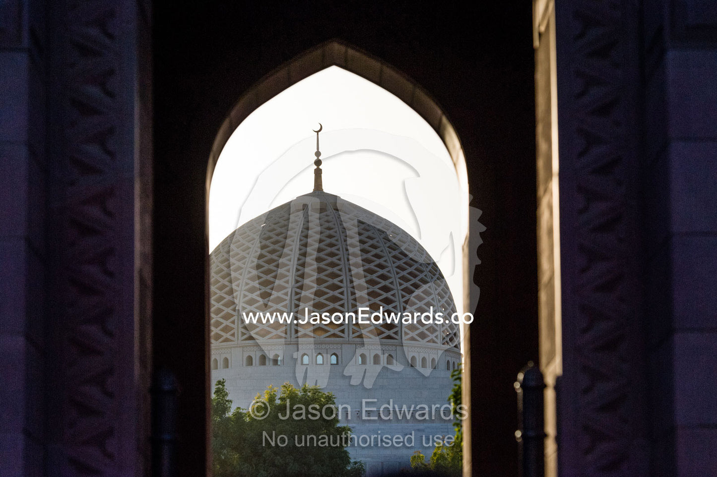 The dome of the Prayer Hall on the Grand Mosque viewed through an archway. Sultan Qaboos Grand Mosque, Muscat, Sultanate of Oman.