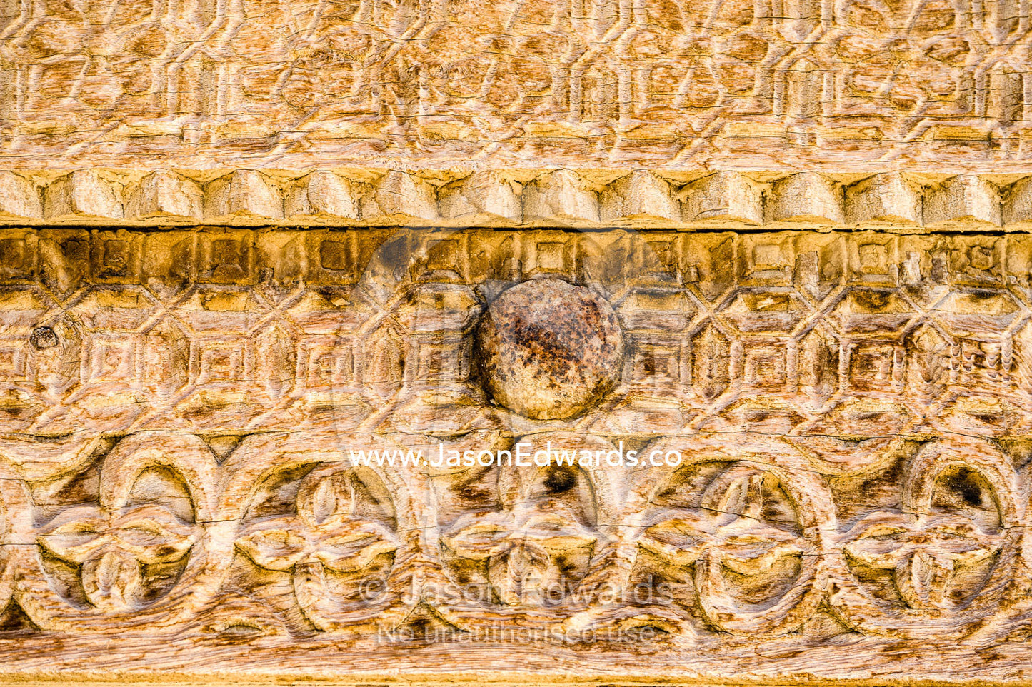 Ornate carving in the timber door frame of a home in an ancient desert village. Ibra, Ash Sharqiyah Region, Sultanate of Oman.