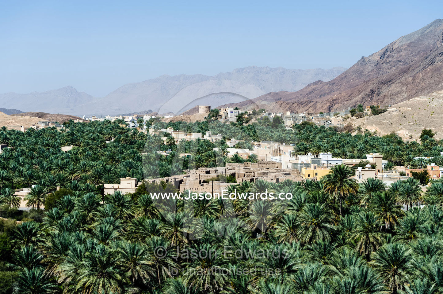 An ancient village surrounded by an irrigated plantation of date palms in a desert valley. Barkat Al Mouz, Sultanate of Oman.