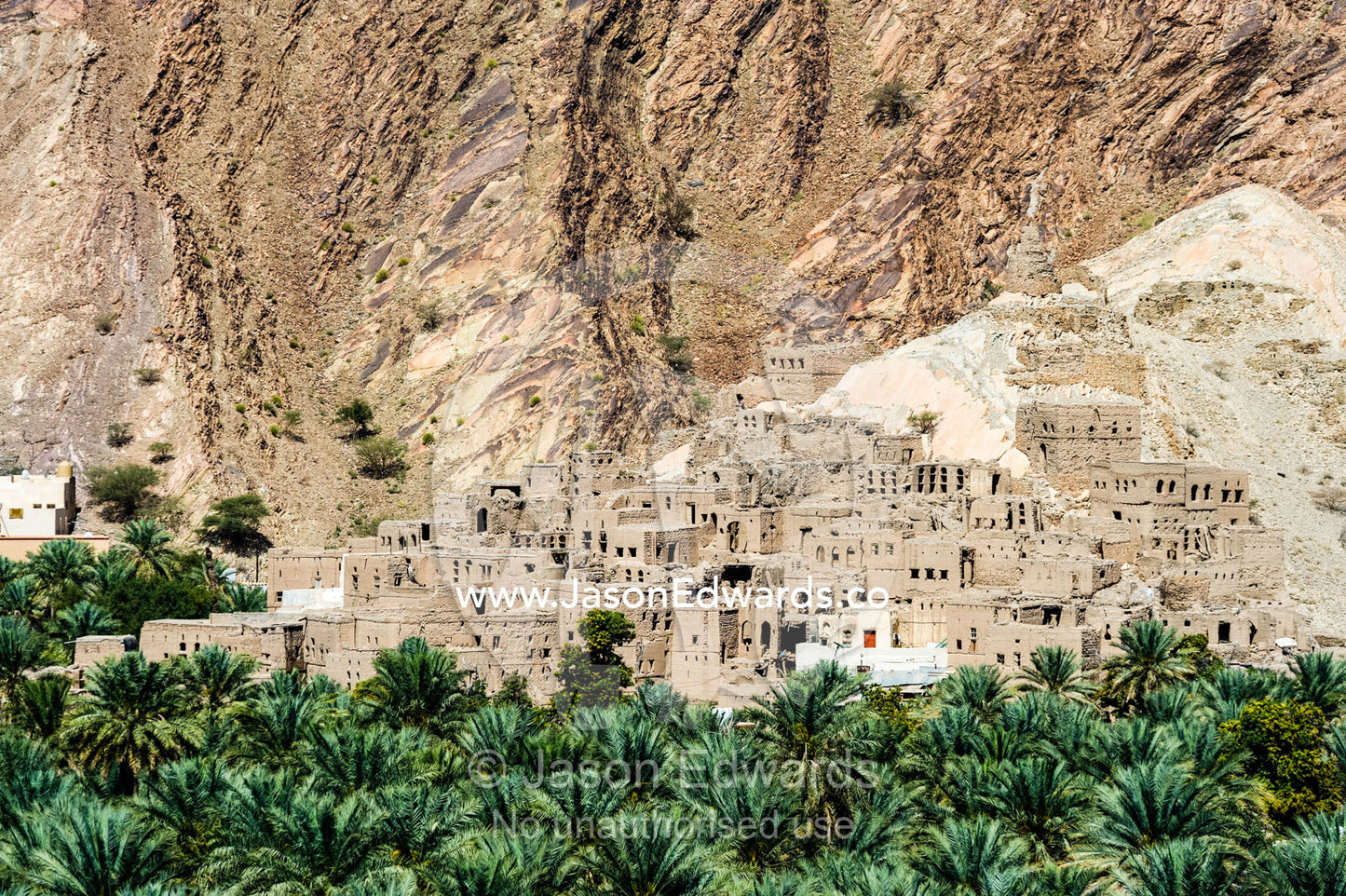 An ancient village surrounded by an irrigated plantation of date palms in a desert valley. Barkat Al Mouz, Sultanate of Oman.