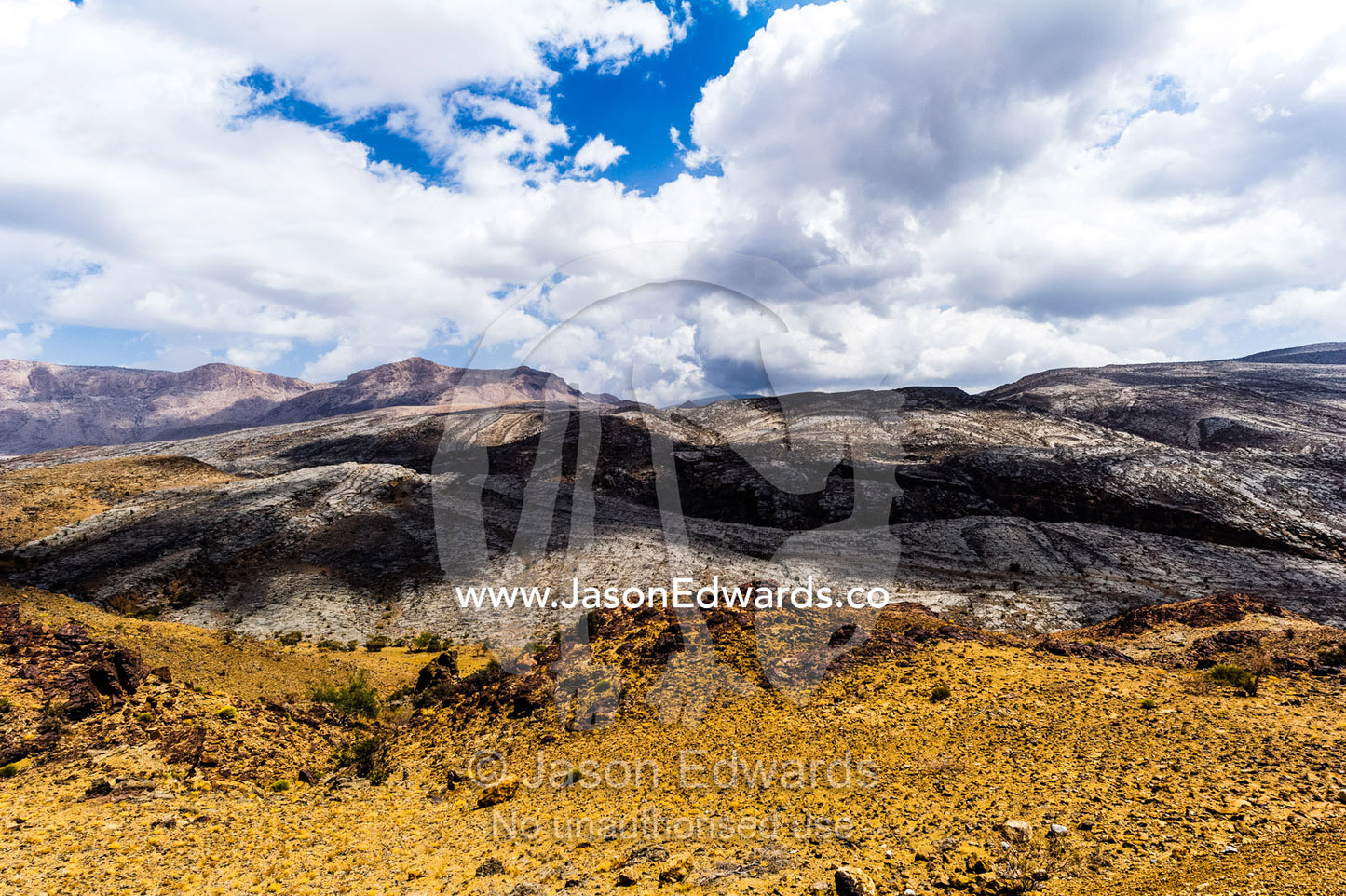 The arid rocky slopes of a prehistoric and volcanic desert landscape. Jebel Shams, Al Hajar Mountains, Sultanate of Oman.