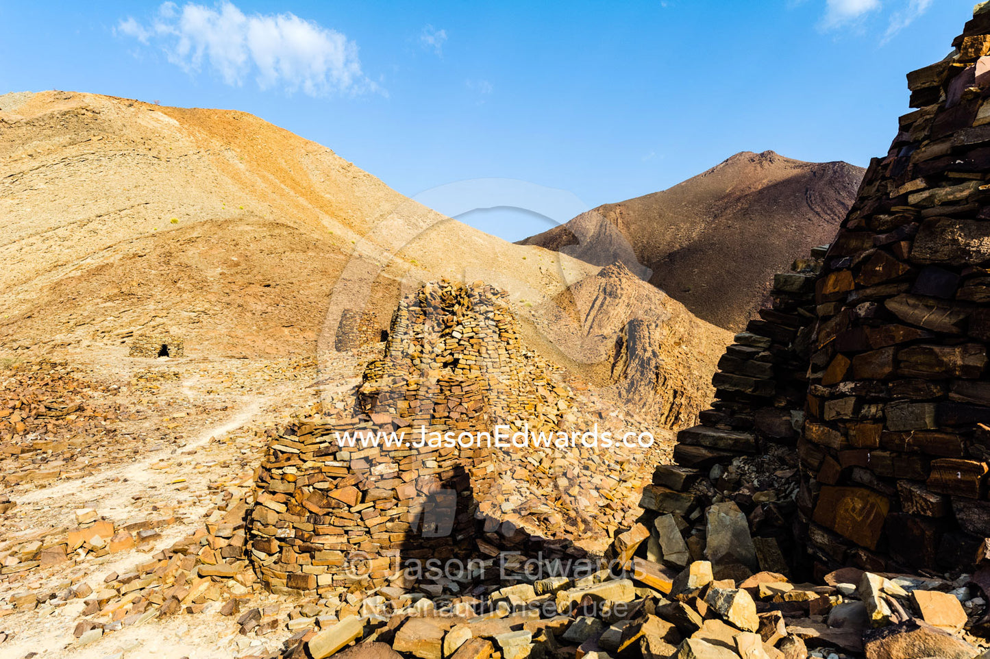 Ancient handmade stone burial mounds and tombs atop a desert ridge. Archaeological Sites of Bat, Al-Ayn, Al Dhahira Region, Sultanate of Oman.