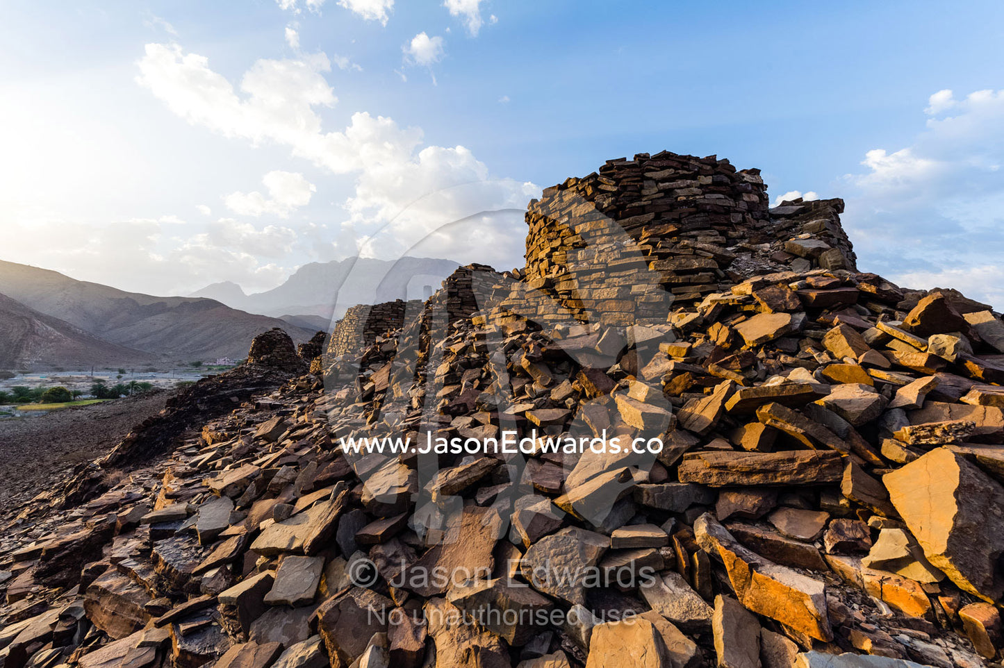 Ancient handmade stone burial mounds and tombs atop a desert ridge. Archaeological Sites of Bat, Al-Ayn, Al Dhahira Region, Sultanate of Oman.