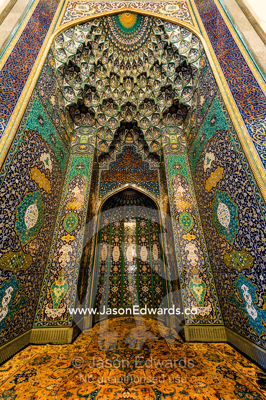 The gold embossed and ornately decorated mihrab in the Prayer Hall of the Grand Mosque. Sultan Qaboos Grand Mosque, Muscat, Sultanate of Oman.