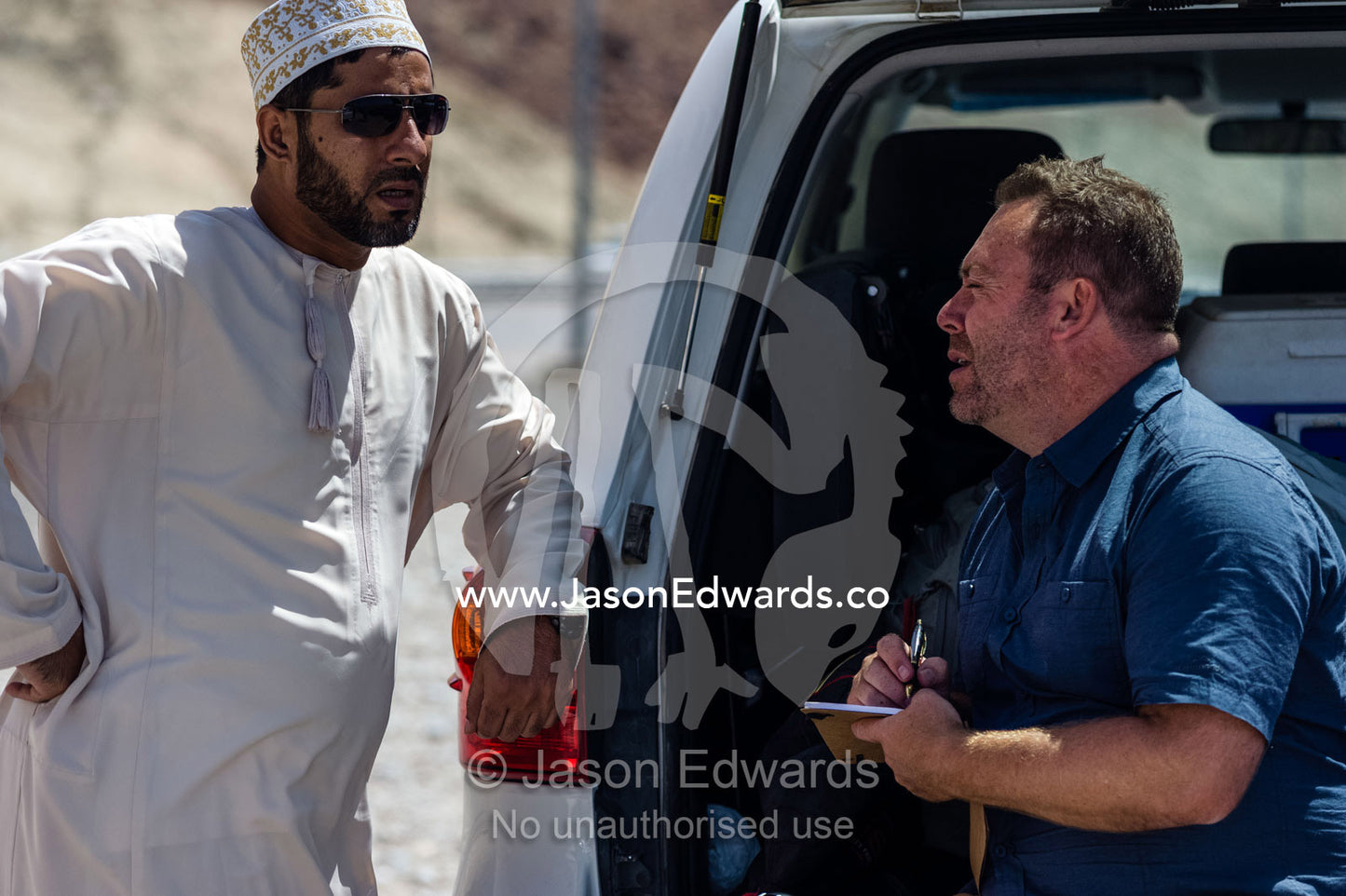 A photographer discussing locations with his fixer. Muscat, Sultanate of Oman.