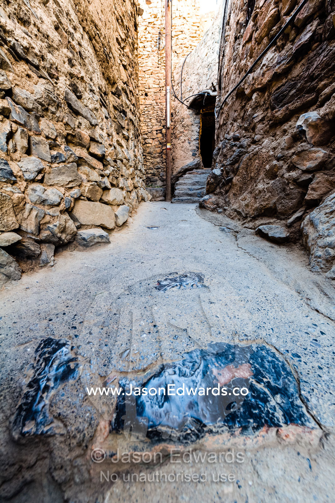 Stone steps polished smooth by foot traffic over hundreds of years in an ancient mud brick village. Misfat Al Abryeen, Al Hajar Mountains, Al Hamra, Ad Dakhiliyah Region, Sultanate of Oman.