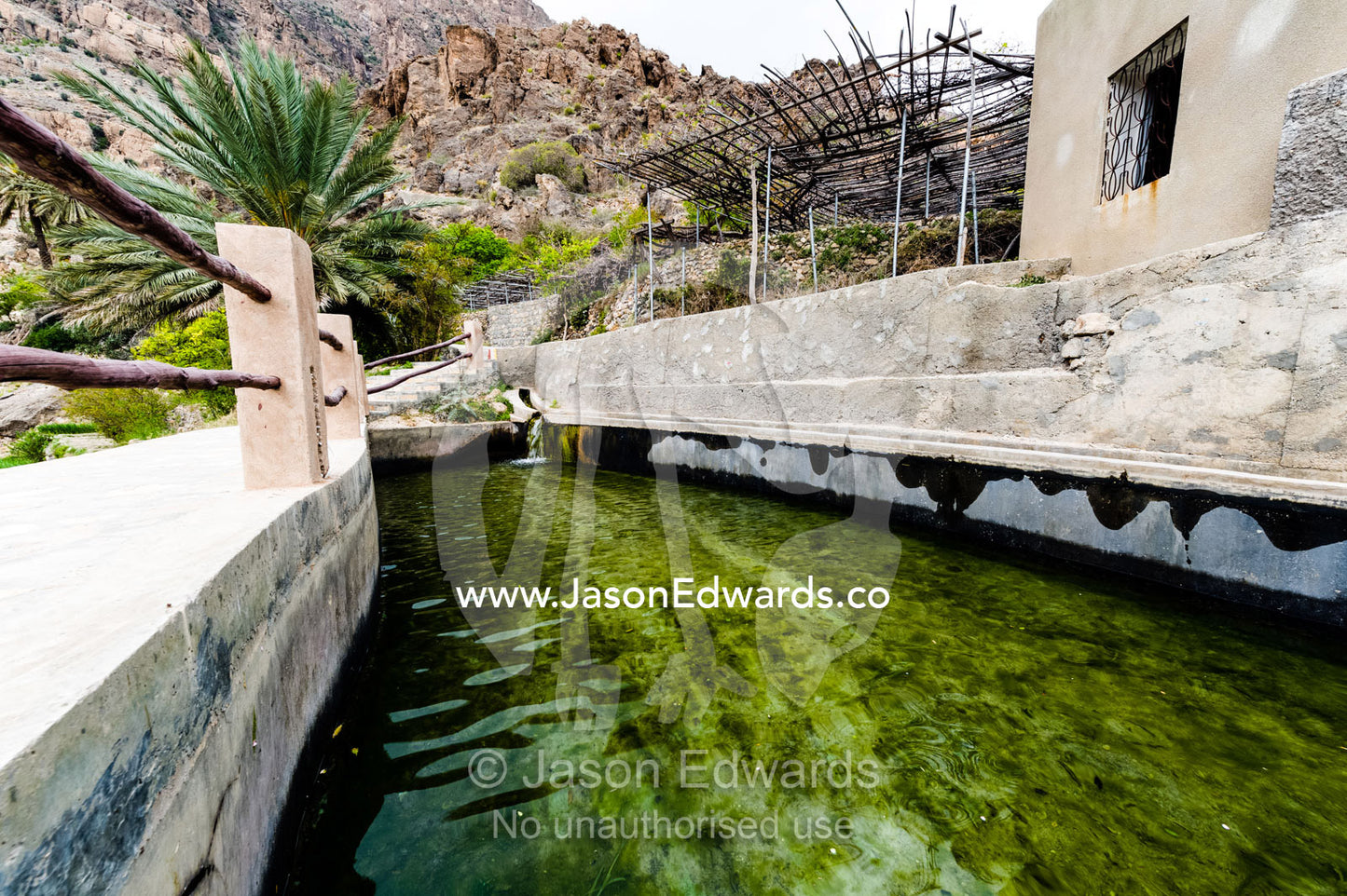 Water gathered from a falaj pools in a village dam in the desert mountains. Wakan Village, Wadi Mastal, Wilayt Nakhal, Al Batinah South Governorate, Sultanate of Oman.