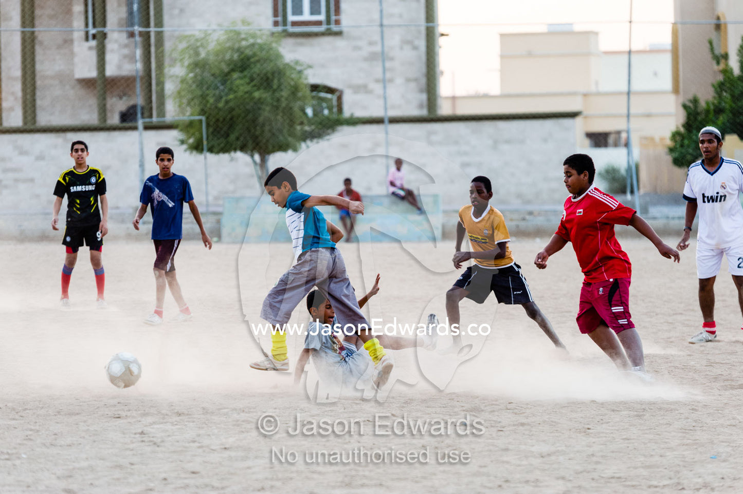 Young boys play a rough and competitive game of football on a dusty pitch. Nakhal Fort, Wilayt Nakhal, Mount Nakhal, Al Batinah South Governorate, Sultanate of Oman.