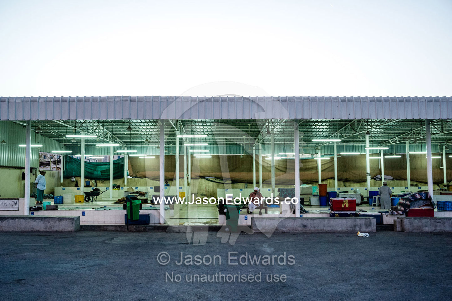 Empty fish market stalls in the pre-dawn light await sellers and buyers. Mutrah Fish Market, Muscat, Gulf of Oman, Sultanate of Oman.