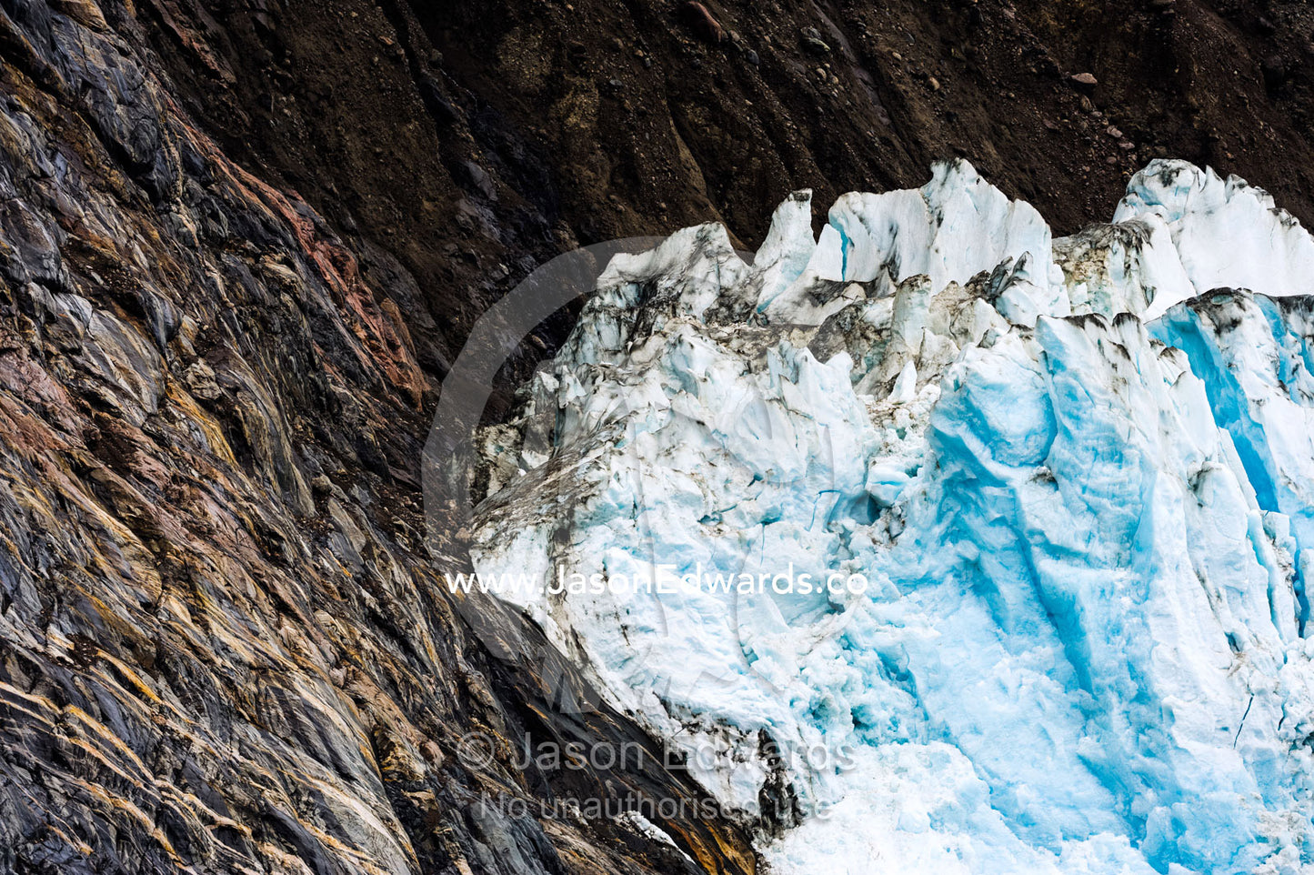 The lip of a glacier grinding against a steep cliff in a fjord. Fjord of Eternity, Maniitsoq, Sukkertoppen, Qeqqata Municipality, Greenland.