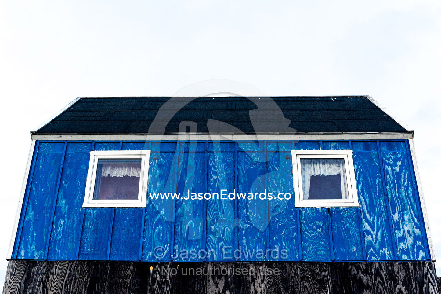 Windows in a blue fisherman's cottage in an Arctic village. Kangaamiut, Gammel Sukkertoppen, Qeqqata Municipality, Greenland.