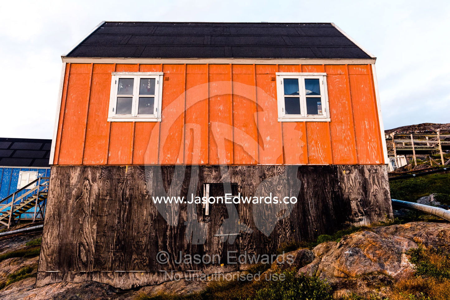 Windows in an orange fisherman's cottage in an Arctic village. Kangaamiut, Gammel Sukkertoppen, Qeqqata Municipality, Greenland.
