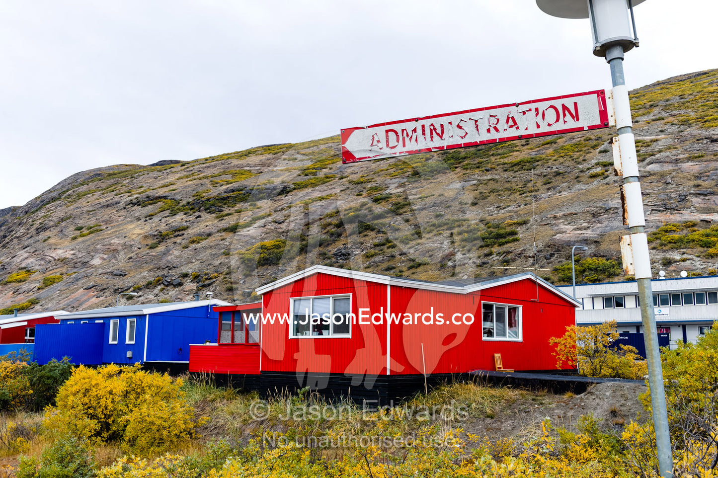 A peeling and weathered Administration sign in an arctic village. Kangerlussuaq, Qeqqata Municipality, Greenland.