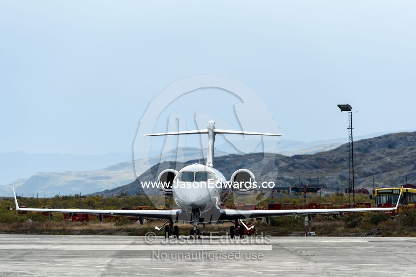 The elegant lines of a small jet parked on the tarmac of an arctic airfield. Kangerlussuaq Airport, Kangerlussuaq, Qeqqata Municipality, Greenland.