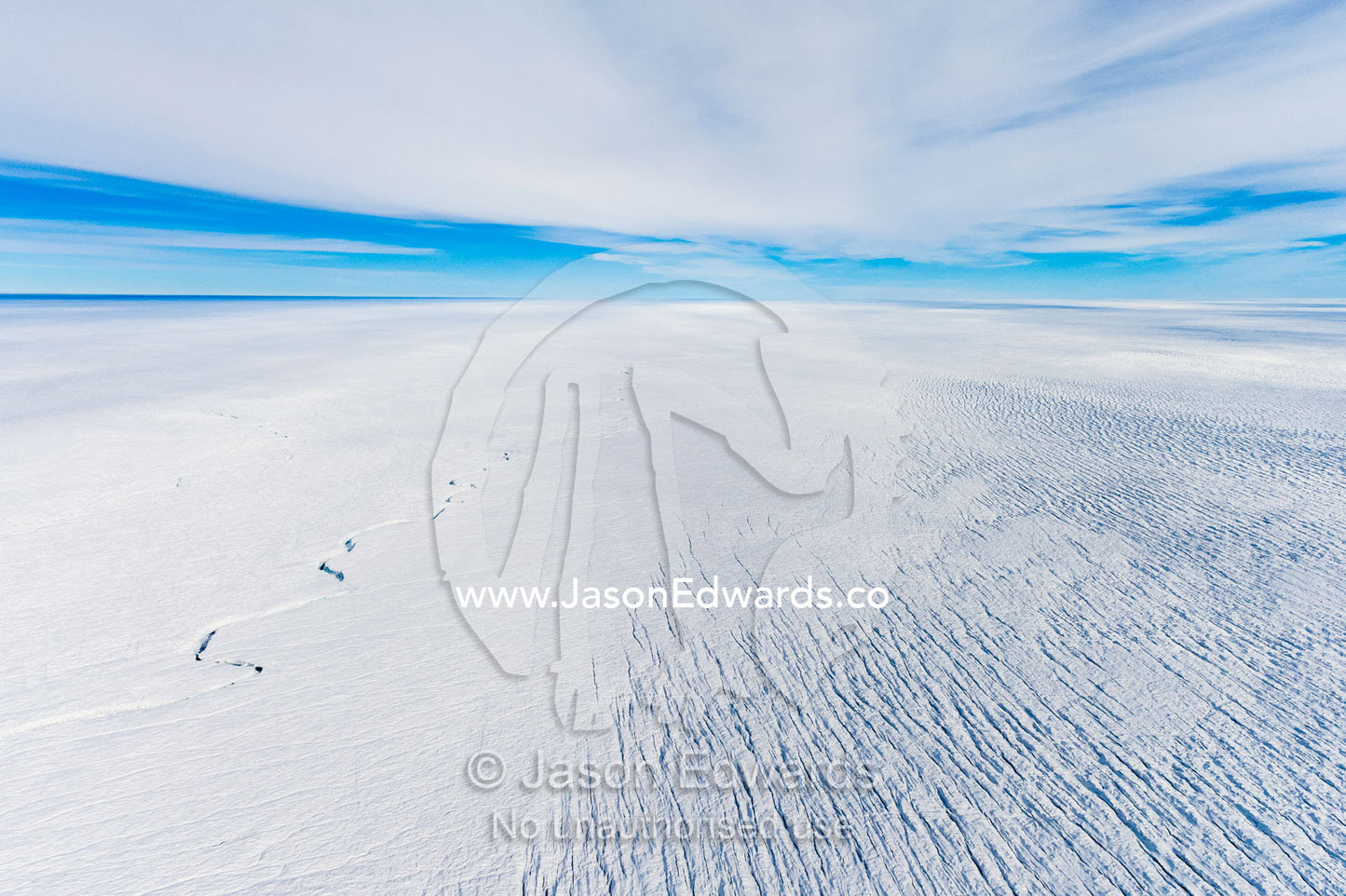 Pressure ridges and crevasse scar the surface of a glacier on the Greenland Ice Sheet. Greenland Ice Sheet, Qeqqata Municipality, Kangerlussuaq, Greenland.