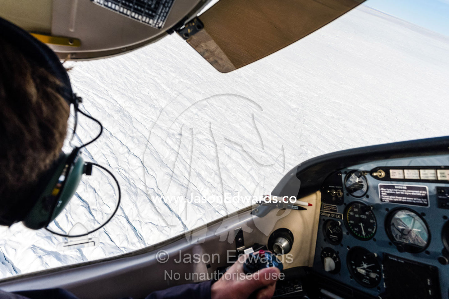 A pilot flying a light plane over the Greenland Ice Sheet. Greenland Ice Sheet, Qeqqata Municipality, Kangerlussuaq, Greenland.