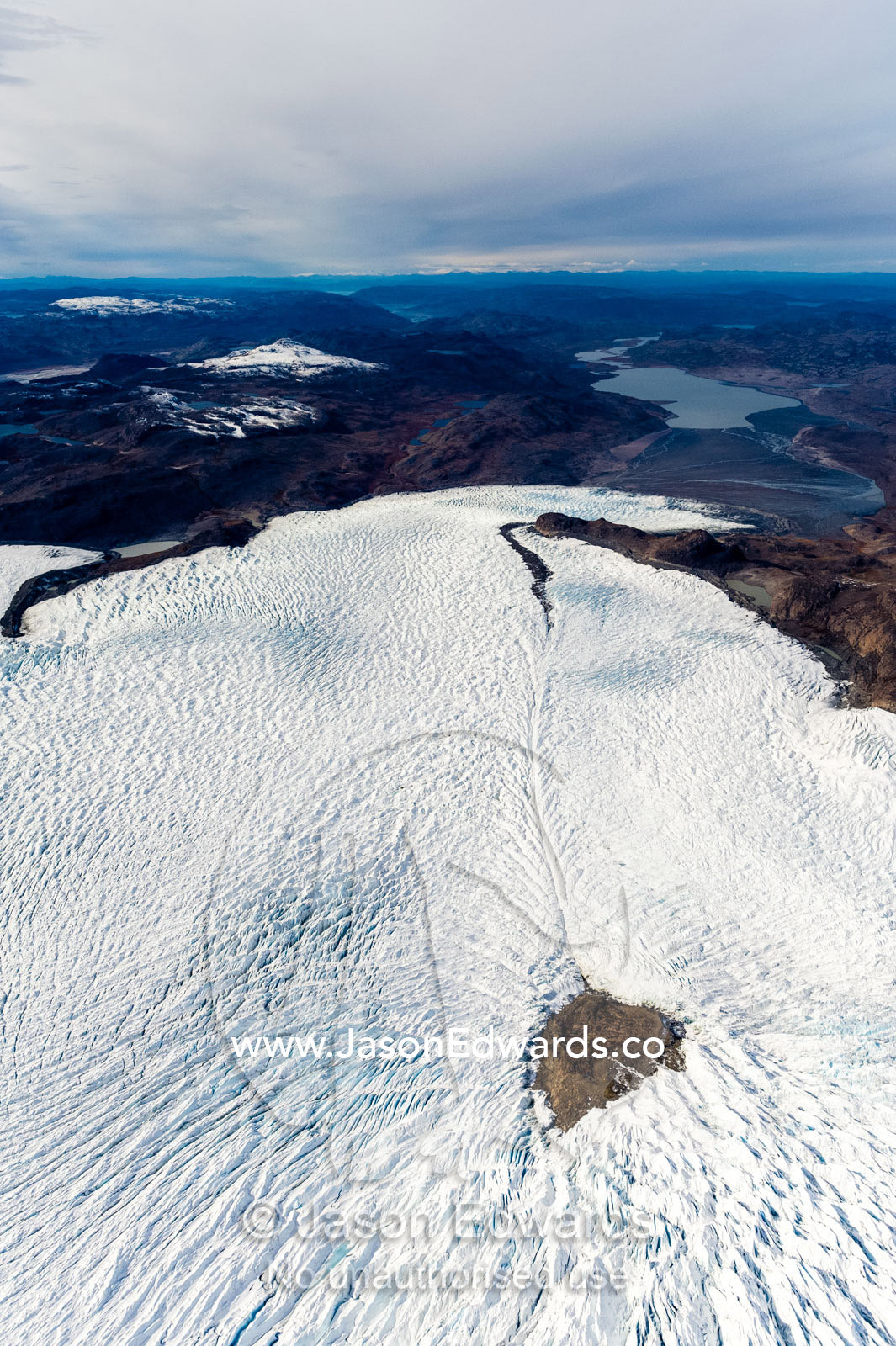 Pressure ridges in a glacier build up around an island in the Greenland Ice Sheet. Russell Glacier, Greenland Ice Sheet, Qeqqata Municipality, Kangerlussuaq, Greenland.
