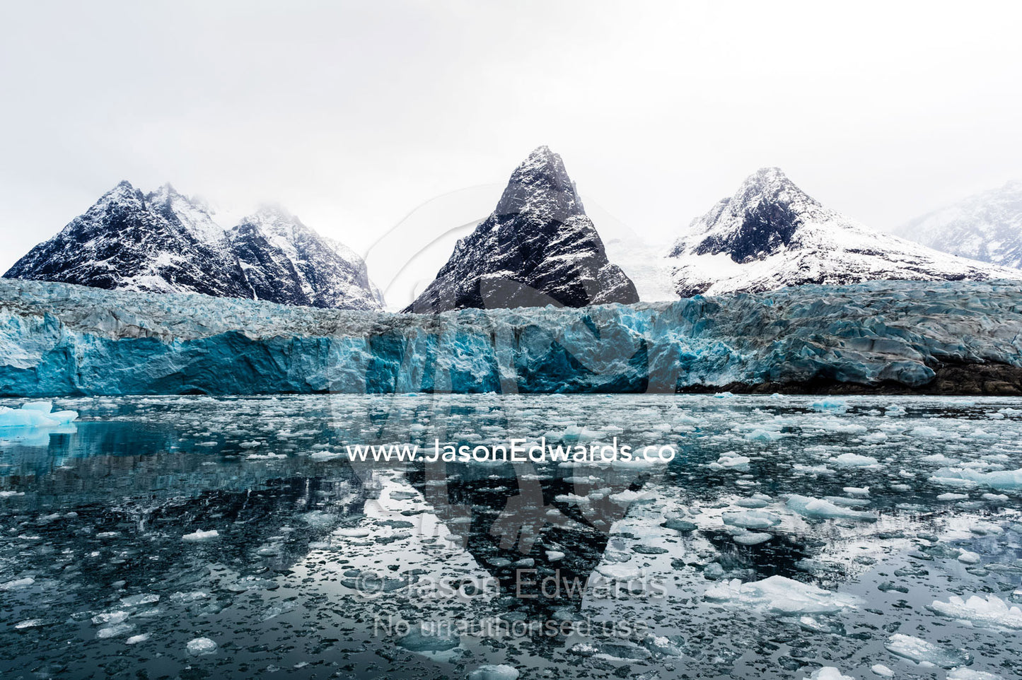 The sheer fracture zone of a glacier sandwiched between alpine peaks in a fjord. Fjord of Eternity, Maniitsoq, Sukkertoppen, Qeqqata Municipality, Greenland.