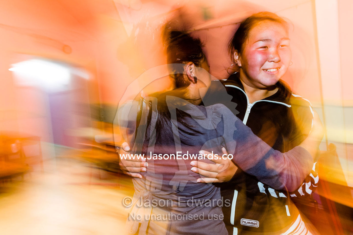 Teenage girls practicing traditional dances in a village hall. Kangaamiut, Gammel Sukkertoppen, Qeqqata Municipality, Greenland.