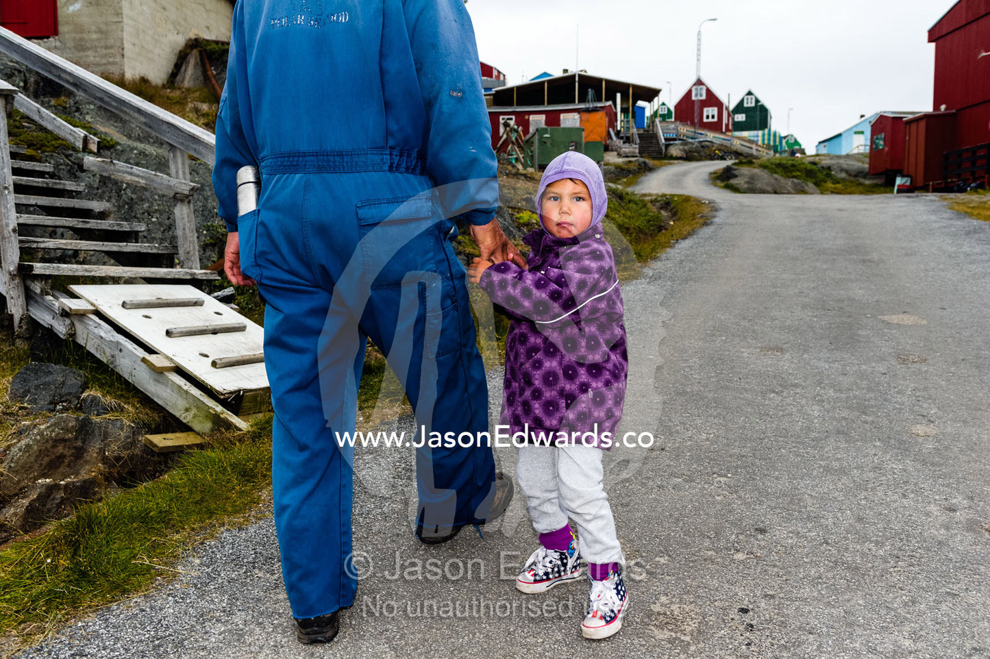 A small girl curious about visitors to her village. Kangaamiut, Gammel Sukkertoppen, Qeqqata Municipality, Greenland.