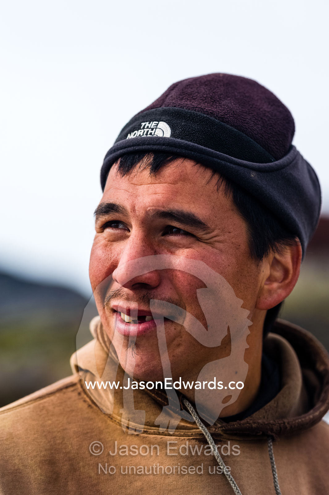 The smiling weathered face of an arctic fisherman. Kangaamiut, Gammel Sukkertoppen, Qeqqata Municipality, Greenland.