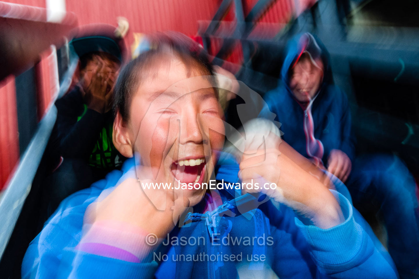 Teenage boys laughing and playing on the steps of a high school in an arctic village. Kangaamiut, Gammel Sukkertoppen, Qeqqata Municipality, Greenland.